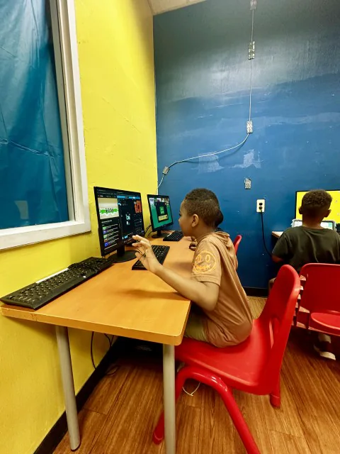 School-age students learning in the academy computer lab