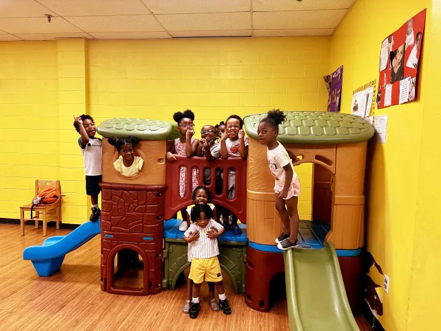 Children enjoying active indoor play on a play structure
