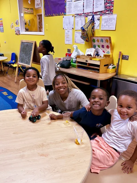 North Wales Academy students smiling around a classroom table